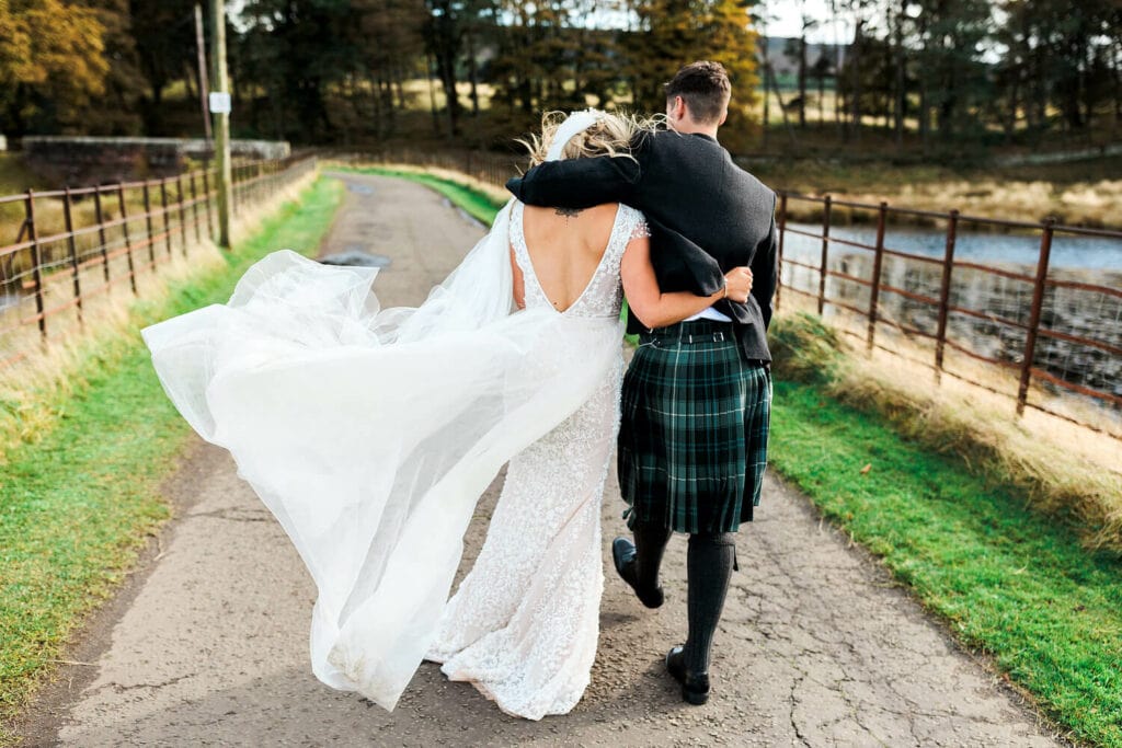 couple walking in the grounds at edinburgh barn wedding