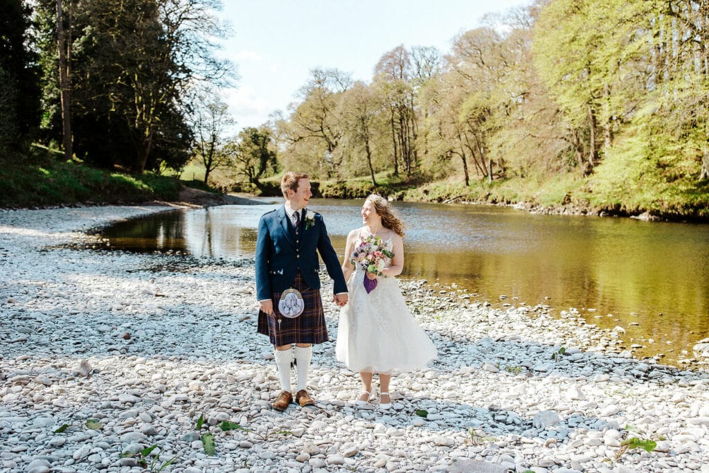 couples down of river bank during their wedding at friars carse 