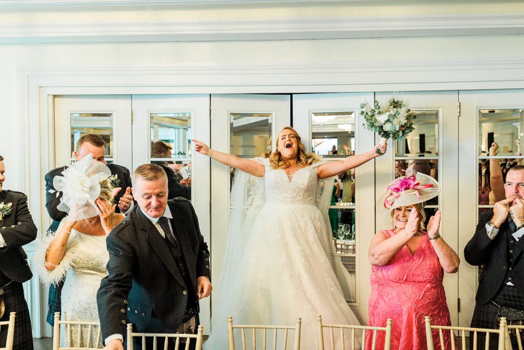 bride celebrating at her loch green wedding during her speeches.