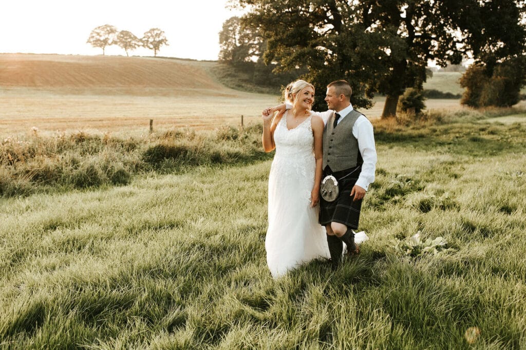 couples portraits in the fields next to fleece at ruleholm